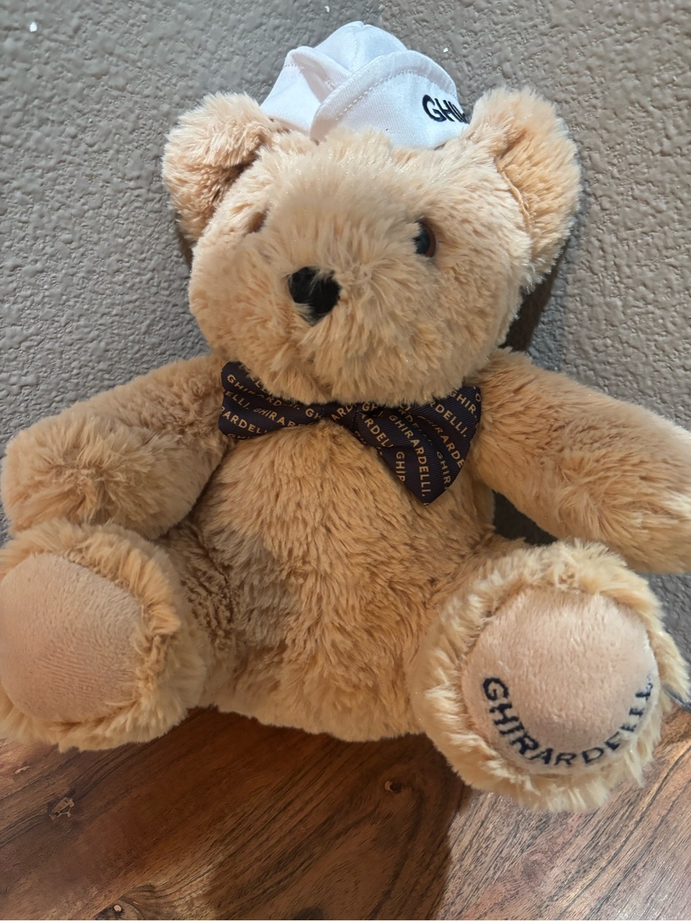 Ghirardelli Plush Teddy Bear in Light Brown with Branded Navy Bow
